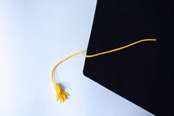 Top view of graduation cap with yellow tassel