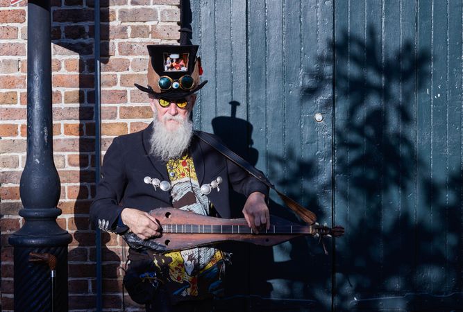 Bearded man with musical instrument performing in the French Quarter, New Orleans