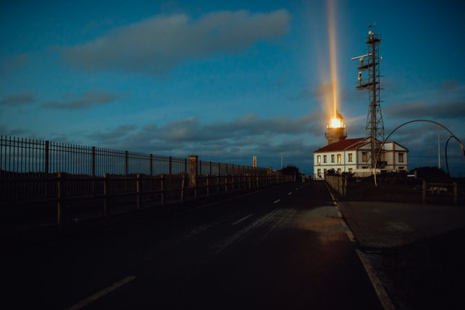 Road and lighthouse in evening