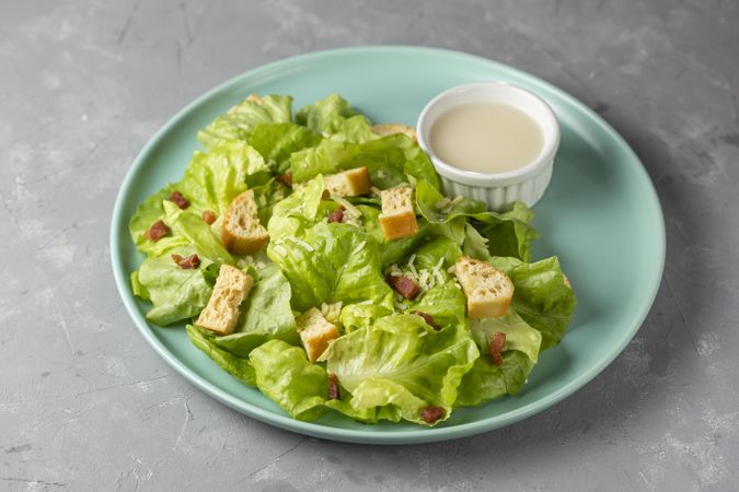 Caesar salad with croutons and bacon.