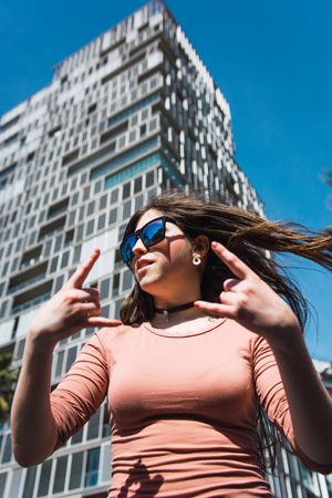 Portrait of 16 year old girl making funny gestures.