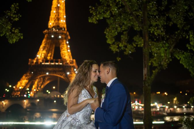 Overjoyed bridal pair enjoying in each other while kissing