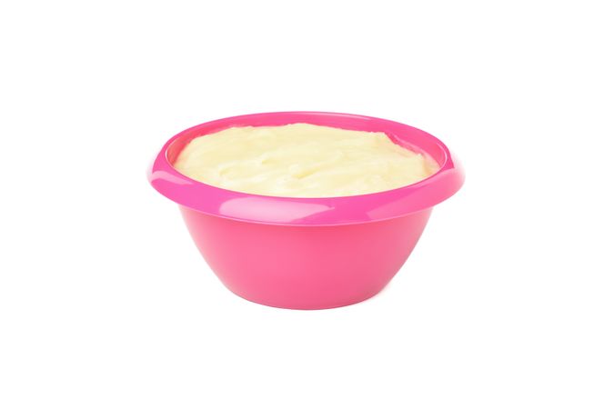 Bowl with healthy baby food isolated on plain background