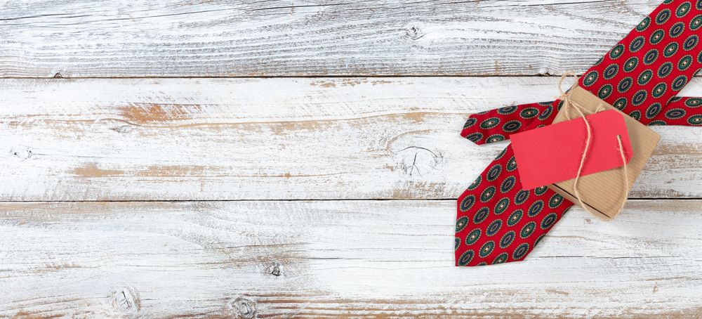 Dotted tie and gift box on rustic wood for Father’s Day background
