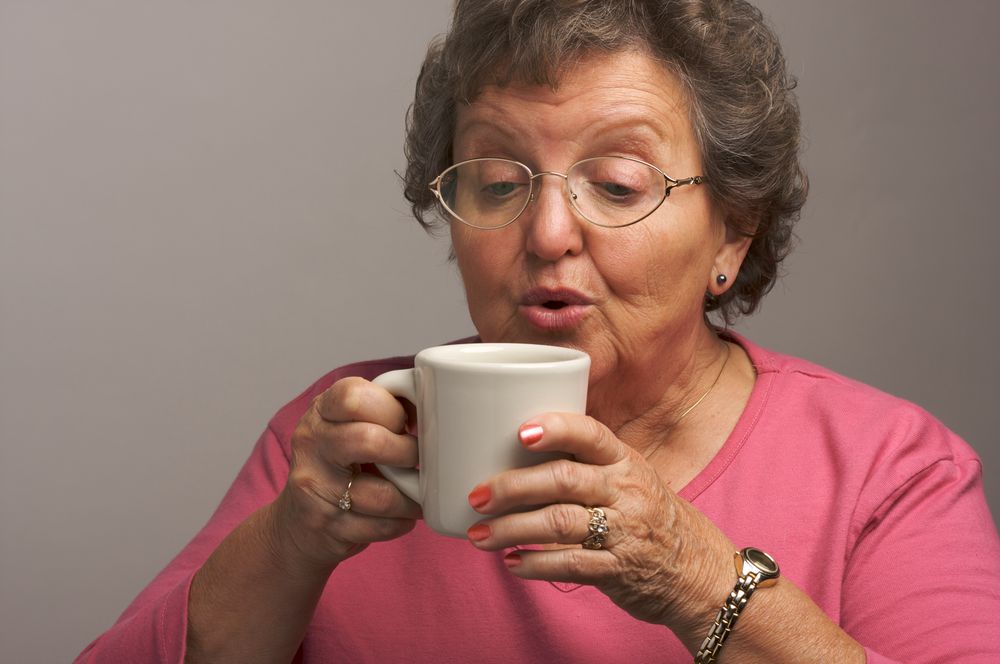 Mature Woman Enjoys Her Coffee