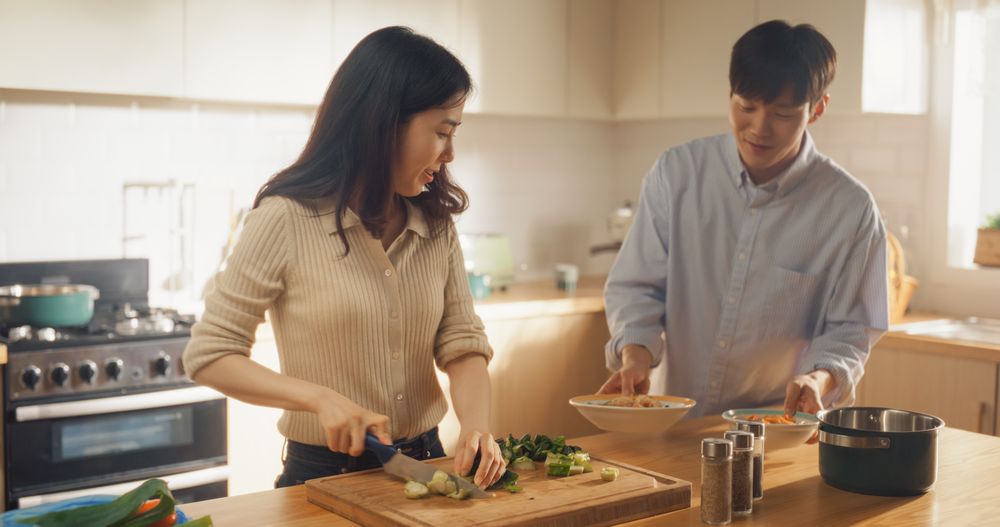 Portrait of a South Korean Young Couple Cooking at Home.