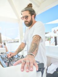 Cool DJ working with equipment while playing music