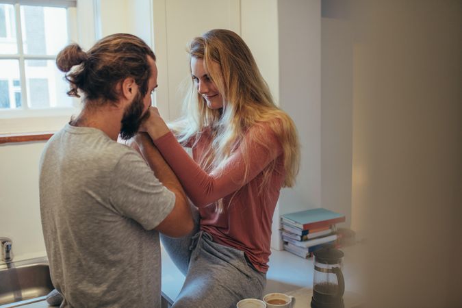 Couple in romantic mood at home looking at each other