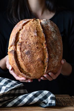 Crop person holding some bread