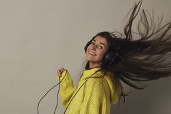 Shocked young woman listening to music in studio