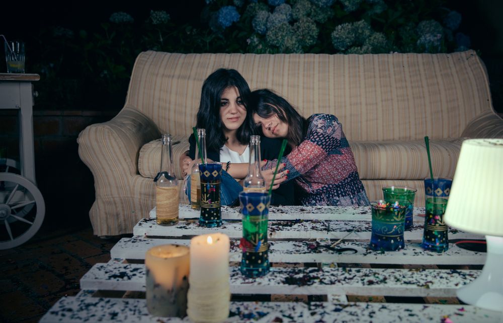 Young drunk women napping after party