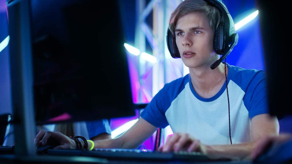 Professional Gamer Plays in Video Game on a eSports Tournament/ in Internet Cafe.