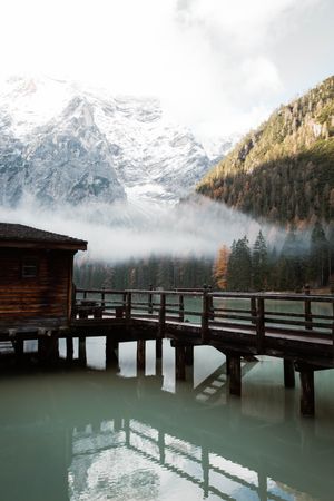 House on stilts on lake near mountains