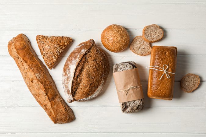 Flat lay composition with bakery products on wooden background, top view and space for text