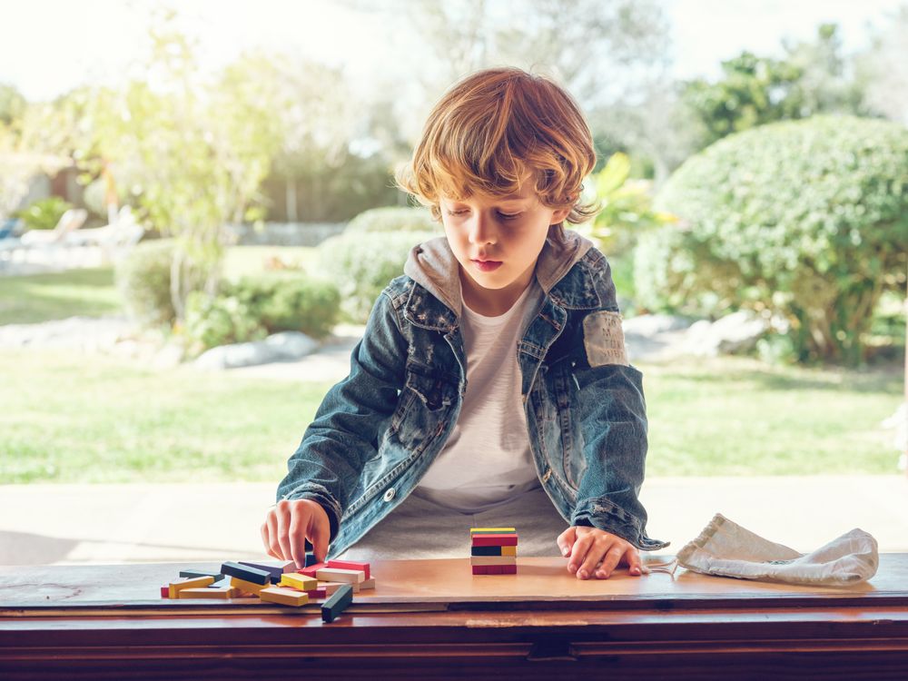 Concentrated kid playing board game