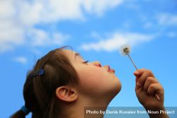 Female child making a wish with a dandelion 5RMwO0