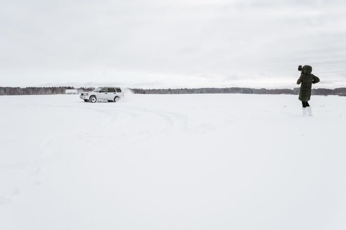 Car driving on icy field