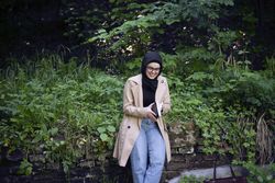 Laughing woman in headscarf with a book