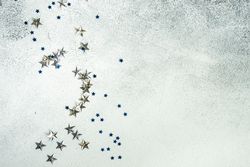 Festive Christmas card concept with silver star confetti decor