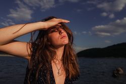 Sensual woman resting on lake shore