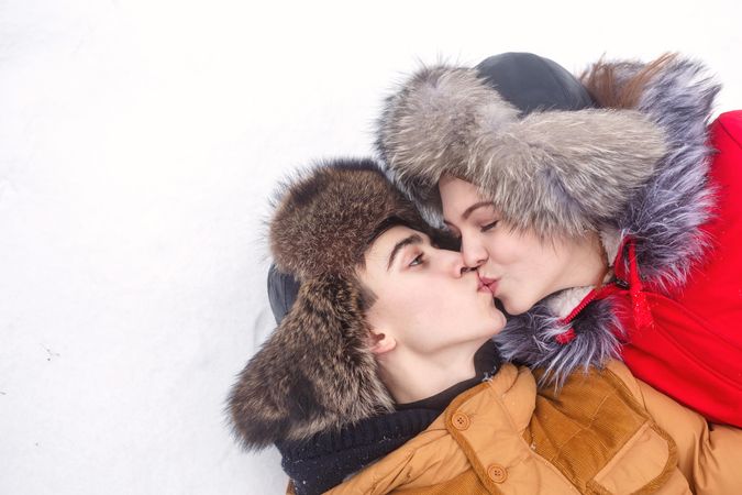 Teenage couple kissing in snow