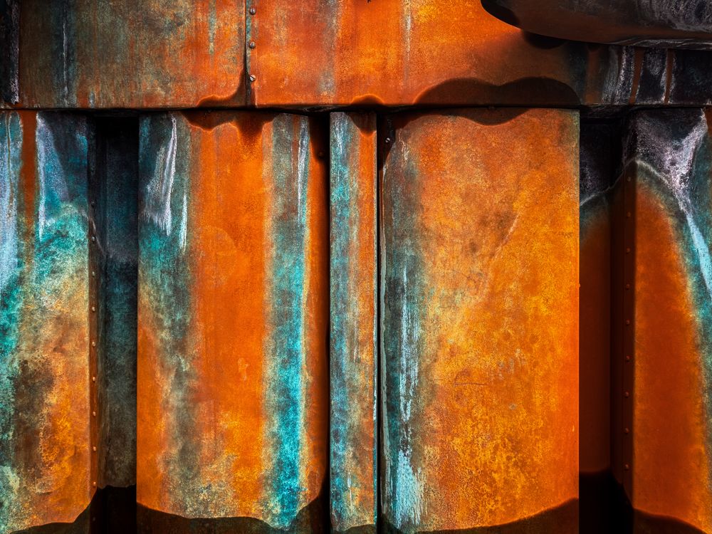 Wall of green and orange corrosion