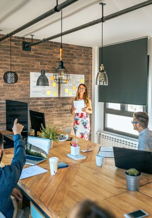 Female manager answering questions in a work meeting
