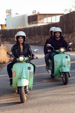 Young people riding motorcycles on city road