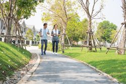 Male and female jogging on walkway