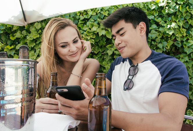 Young couple drinking beer on a sunny day