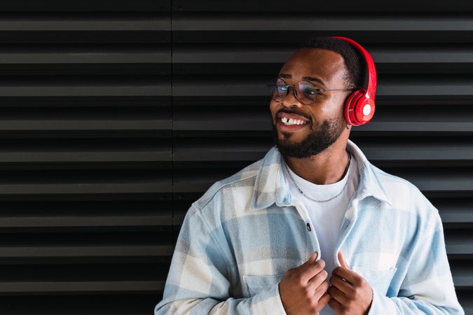 Smiling Black man in headphones and jacket