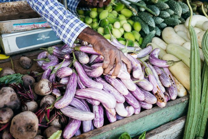 Vendor with fresh vegetables for sale displayed at Sri Lankan market