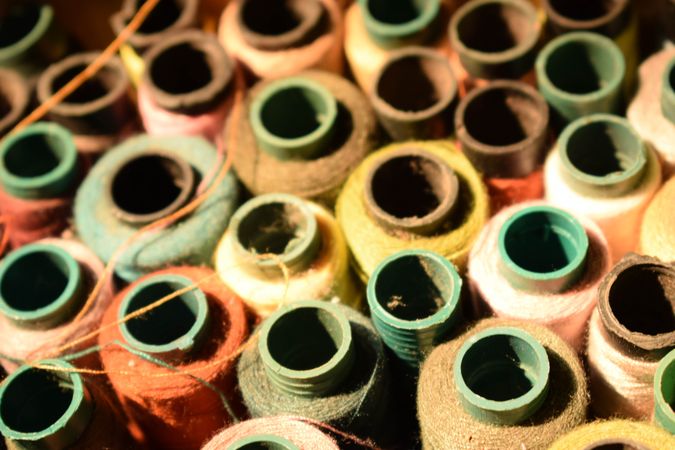 Tops of colored spools of string for sewing machine