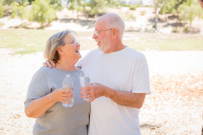 Happy Healthy Mature Couple with Water Bottles