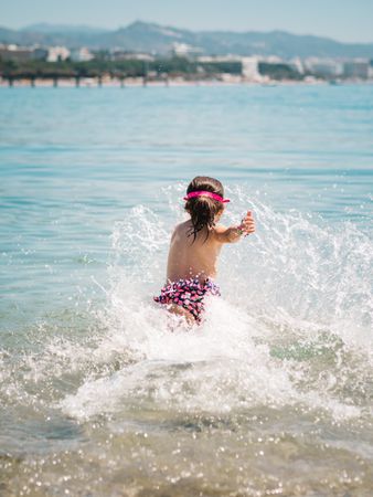 Cheerful girl having fun in warm sea