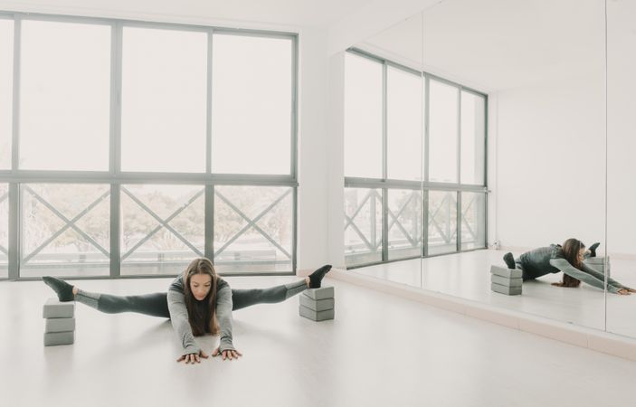 Flexible woman stretching in studio