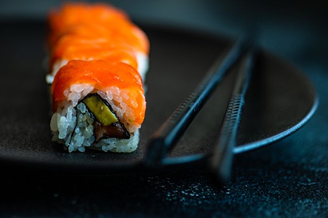 Salmon sushi rolls served on stone slate