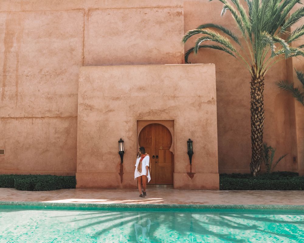 Woman standing beside swimming pool