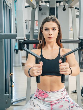 Slim woman exercising on resistance trainer