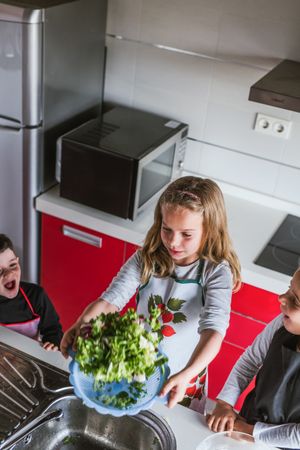 Kids playing while preparing vegetables for salad