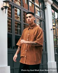 Stylish young man with tattoos in corduroy shirt 0Pz924