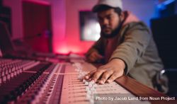 Focus on young man hands working on music mixer 0VWmv5