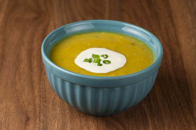 Bowl with pumpkin soup on the table.