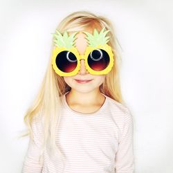 Blonde girl wearing big pineapple sunglasses