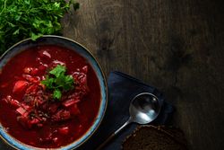 Ukrainian beetroot soup borscht on wooden table