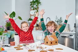 Happy children near gingerbread house
