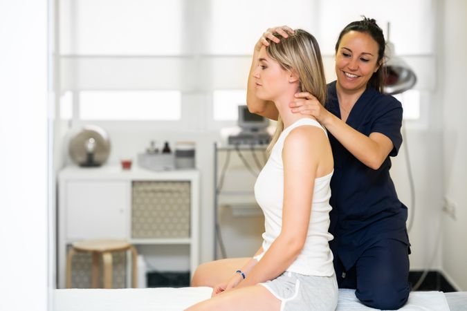Physio working on her female’s client’s neck