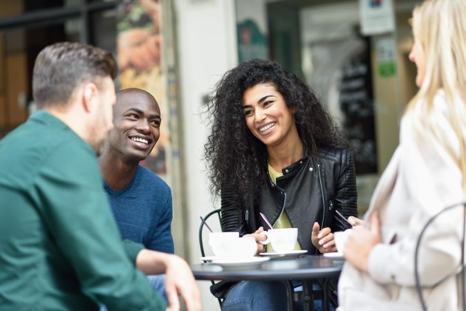 Multi-ethnic group of friends having a coffee together