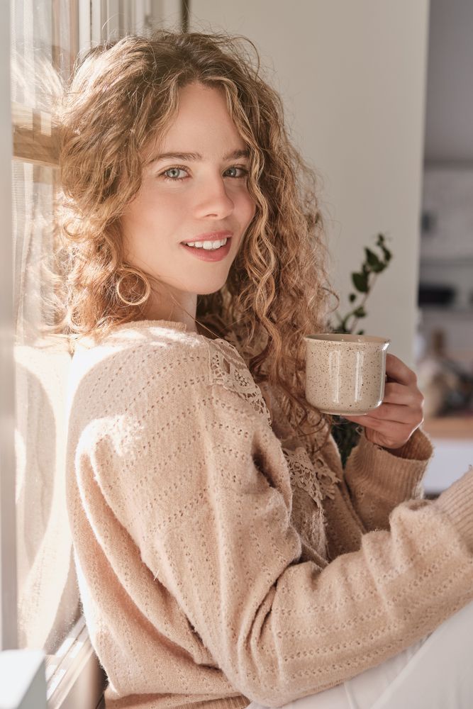 Smiling woman with cup of coffee