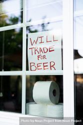 Window sign asking to trade toilet paper for beer 4BaXd5